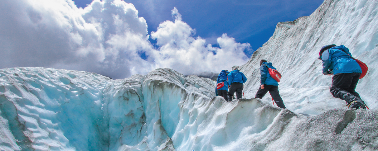 People hiking up a mountain through ice